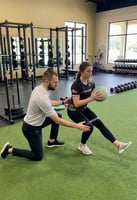 Patient working with a provider at a sports physical therapy clinic in San Antonio, TX during a return-to-sport therapeutic exercise session
